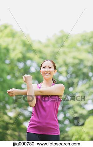 Young Japanese girl stretching in the park View Large Photo Image Stock Image - Young Japanese girl stretching in the park. Fotosearch