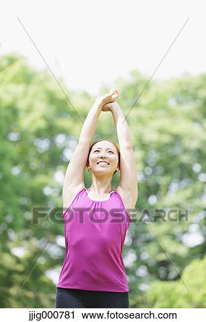 Young Japanese girl stretching in the park View Large Photo Image Stock Image - Young Japanese girl stretching in the park. Fotosearch