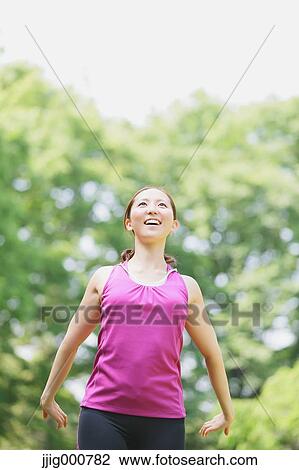 Young Japanese girl stretching in the park View Large Photo Image Stock Image - Young Japanese girl stretching in the park. Fotosearch
