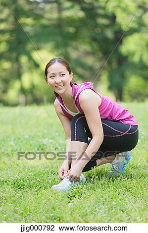 Young Japanese girl stretching in the park View Large Photo Image Stock Image - Young Japanese girl stretching in the park. Fotosearch