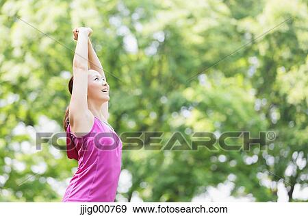 Young Japanese girl stretching in the park View Large Photo Image Stock Photo - Young Japanese girl stretching in the park. Fotosearch