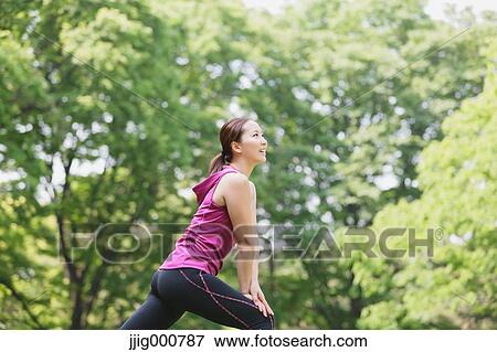 Young Japanese girl stretching in the park View Large Photo Image Stock Photo - Young Japanese girl stretching in the park. Fotosearch