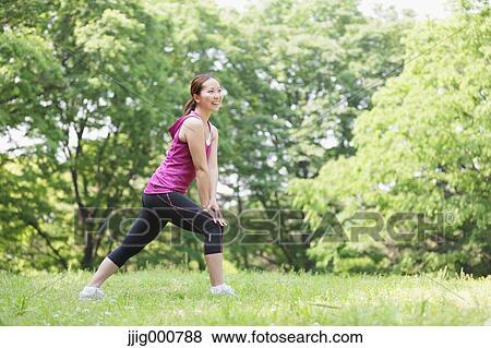 Stock Photo - Young Japanese girl stretching in the park. Fotosearch