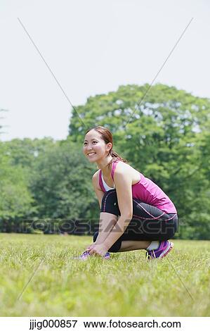 Stock Photo - Young Japanese girl stretching in the park. Fotosearch