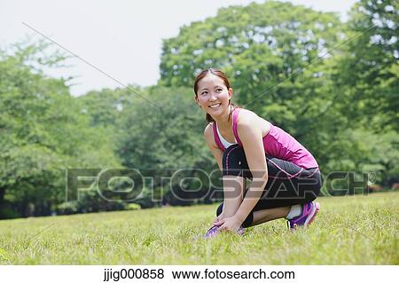 Young Japanese girl stretching in the park View Large Photo Image Stock Photo - Young Japanese girl stretching in the park. Fotosearch
