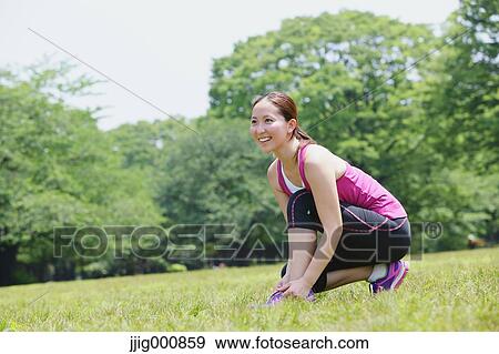 Young Japanese girl stretching in the park View Large Photo Image Stock Photo - Young Japanese girl stretching in the park. Fotosearch