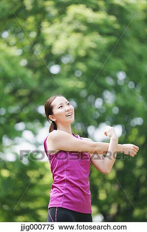 Young Japanese girl stretching in the park View Large Photo Image Stock Photography - Young Japanese girl stretching in the park. Fotosearch