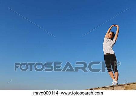 Picture - Young Japanese girl stretching. Fotosearch