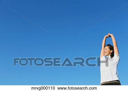 Stock Image - Young Japanese girl stretching. Fotosearch