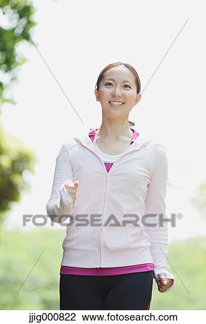 Young Japanese girl walking in the park View Large Photo Image Stock Image - Young Japanese girl walking in the park. Fotosearch