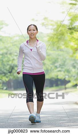Young Japanese girl walking in the park View Large Photo Image Stock Image - Young Japanese girl walking in the park. Fotosearch