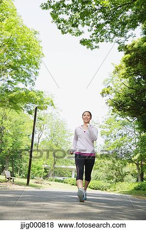 Young Japanese girl walking in the park View Large Photo Image Stock Photo - Young Japanese girl walking in the park. Fotosearch