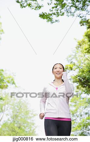 Stock Photograph - Young Japanese girl walking in the park. Fotosearch