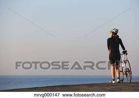 Young Japanese girl with racing bike at sunset View Large Photo Image Stock Photo - Young Japanese girl with racing bike at sunset. Fotosearch