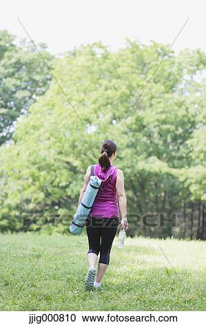 Young Japanese girl with water bottle after training in the park View Large Photo Image Stock Image - Young Japanese girl with water bottle after training in the park. Fotosearch