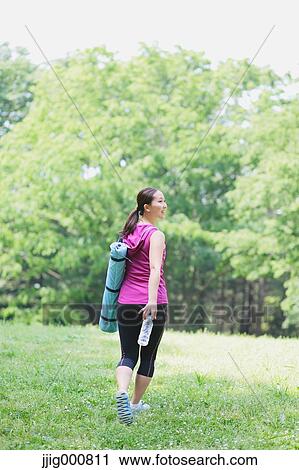 Young Japanese girl with water bottle after training in the park View Large Photo Image Stock Image - Young Japanese girl with water bottle after training in the park. Fotosearch