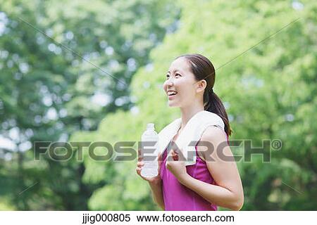 Young Japanese girl with water bottle after training in the park View Large Photo Image Stock Photography - Young Japanese girl with water bottle after training in the park. Fotosearch