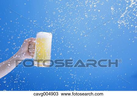 Man holding draft beer and water splash View Large Photo Image Stock Image - Man holding draft beer and water splash. Fotosearch
