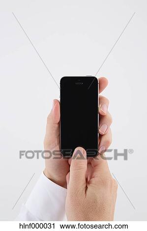 Mid adult man holding smartphone View Large Photo Image Stock Image - Mid adult man holding smartphone. Fotosearch
