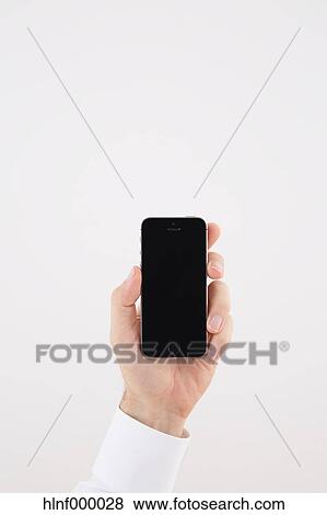 Mid adult man holding smartphone View Large Photo Image Stock Photo - Mid adult man holding smartphone. Fotosearch