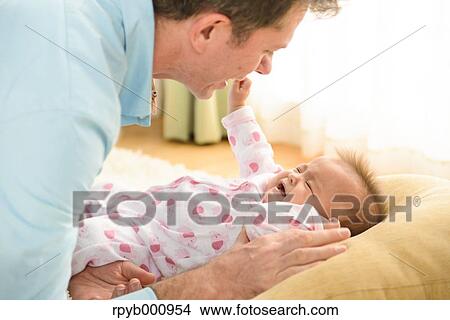 Newborn with his dad in the house View Large Photo Image Picture - Newborn with his dad in the house. Fotosearch