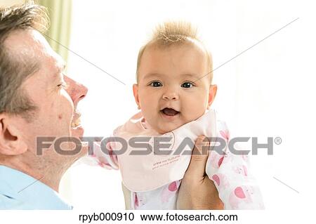 Stock Image - Newborn with his dad in the house. Fotosearch