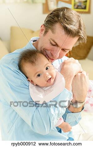 Newborn with his dad in the house View Large Photo Image Stock Image - Newborn with his dad in the house. Fotosearch