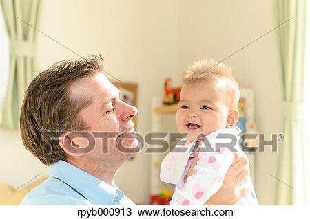 Newborn with his dad in the house View Large Photo Image Stock Image - Newborn with his dad in the house. Fotosearch