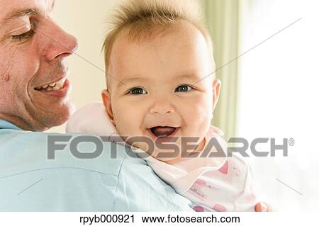 Stock Image - Newborn with his dad in the house. Fotosearch