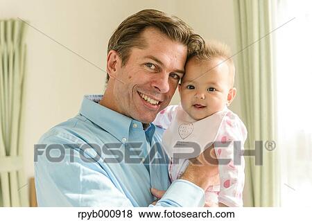 Newborn with his dad in the house View Large Photo Image Stock Photo - Newborn with his dad in the house. Fotosearch