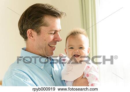 Newborn with his dad in the house View Large Photo Image Stock Photo - Newborn with his dad in the house. Fotosearch