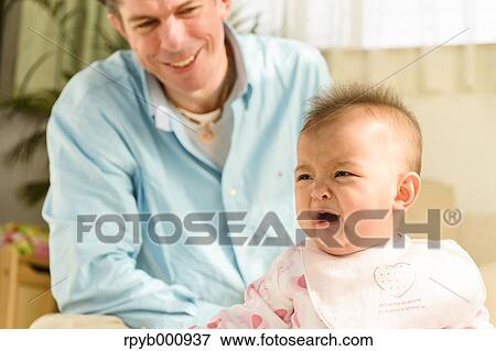 Newborn with his dad in the house View Large Photo Image Stock Photo - Newborn with his dad in the house. Fotosearch