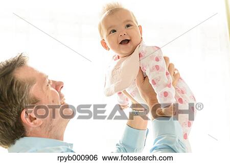 Newborn with his dad in the house View Large Photo Image Stock Photograph - Newborn with his dad in the house. Fotosearch