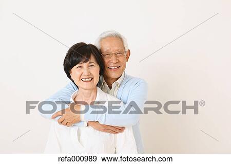 Senior adult Japanese couple against white wall View Large Photo Image Stock Photo - Senior adult Japanese couple against white wall. Fotosearch