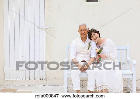Stock Photo - Senior adult Japanese couple celebrating. Fotosearch