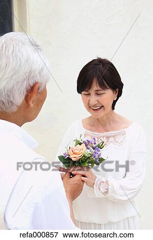 Stock Photo - Senior adult Japanese couple celebrating. Fotosearch
