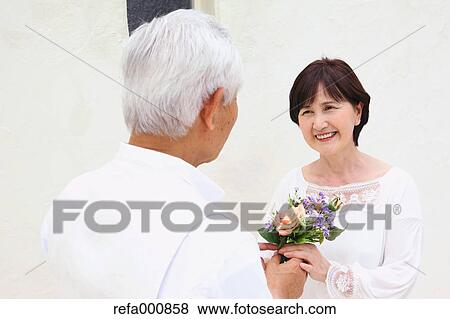 Stock Photo - Senior adult Japanese couple celebrating. Fotosearch