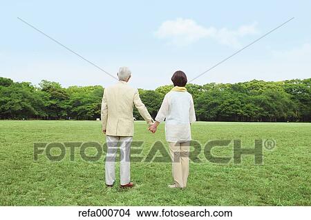 Picture - Senior adult Japanese couple in a park. Fotosearch