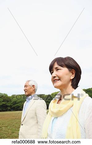 Stock Photo - Senior adult Japanese couple in a park. Fotosearch