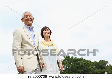 Stock Photo - Senior adult Japanese couple in a park. Fotosearch