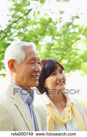 Stock Photo - Senior adult Japanese couple in a park. Fotosearch
