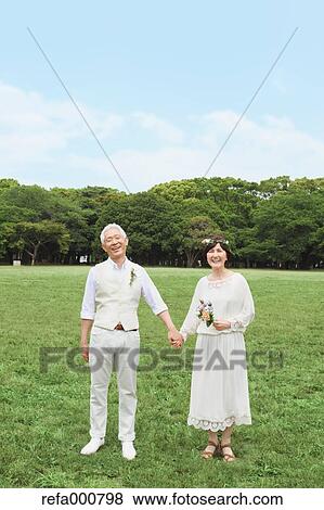 Stock Photo - Senior adult Japanese couple in a park. Fotosearch