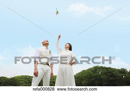 Stock Photo - Senior adult Japanese couple in a park. Fotosearch