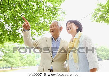 Stock Photograph - Senior adult Japanese couple in a park. Fotosearch