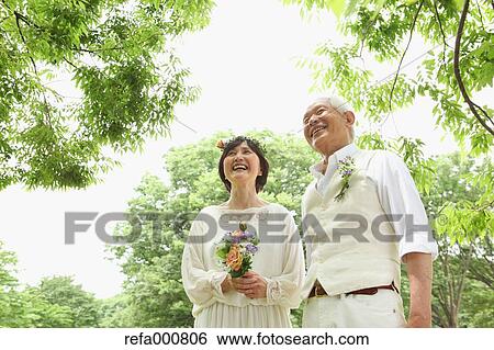 Stock Photograph - Senior adult Japanese couple in a park. Fotosearch