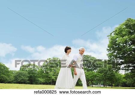 Stock Photography - Senior adult Japanese couple in a park. Fotosearch