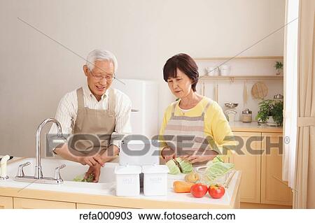 Senior adult Japanese couple in the kitchen View Large Photo Image Stock Image - Senior adult Japanese couple in the kitchen. Fotosearch