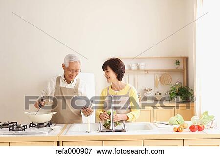 Senior adult Japanese couple in the kitchen View Large Photo Image Stock Photo - Senior adult Japanese couple in the kitchen. Fotosearch