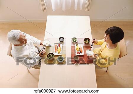 Stock Photo - Senior adult Japanese couple in the kitchen. Fotosearch
