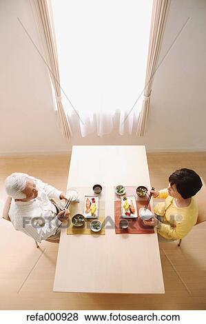 Stock Photo - Senior adult Japanese couple in the kitchen. Fotosearch